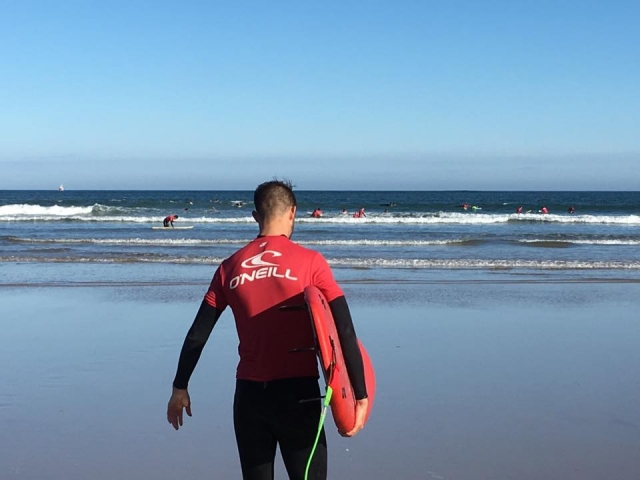  Walking towards the water with the board 